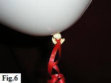 Tying curling ribbon to latex balloon