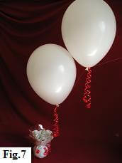 Latex balloons in a 'String-of-Pearls' arch with decorative curling ribbons