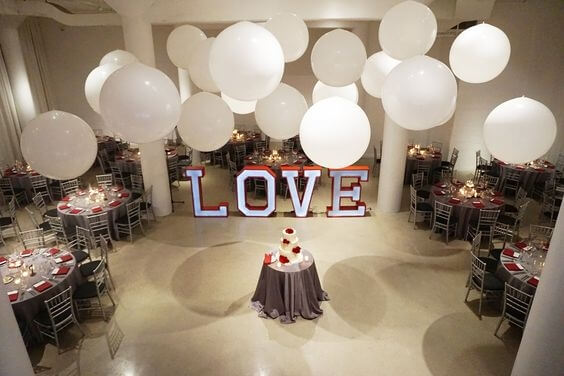 3 feet balloons hanging from ceiling at a wedding reception