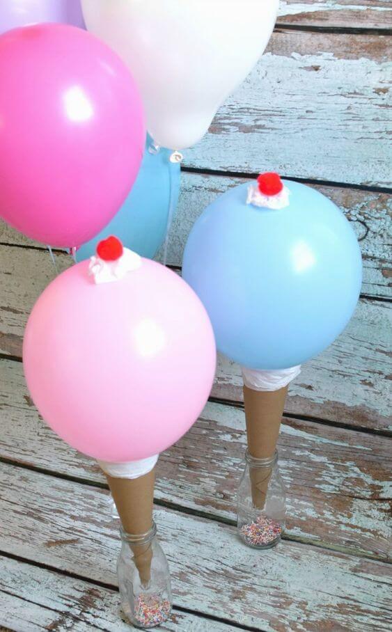 Pastel colored balloon ice cream cones with little glass bottles as holders.