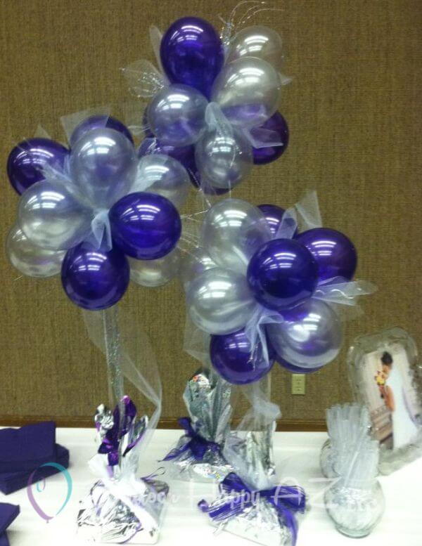 Three balloon topiary trees with transparent blue and clear balloons on a wedding table.