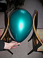 Measure the balloon size between the back of two chairs.