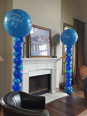 Balloon columns near a non-active fireplace (Image credit: rainbowballooncompany.com)