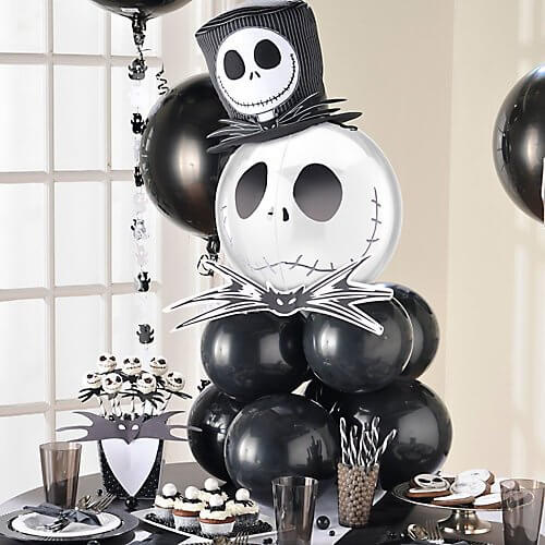 Black and white photo of an air filled Halloween themed balloon centerpiece, with a Jack Skellington balloon on top.