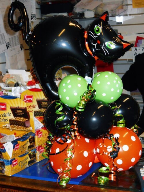 Cute Halloween balloon decor with a black cat on top.