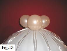 Top of the hot air balloon model adorned with four 5 inch balloons in pearl color.
