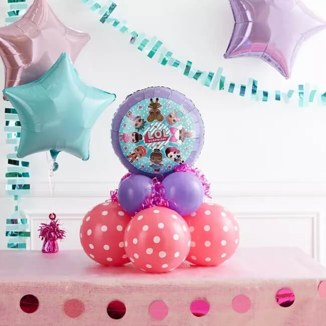Small balloon centerpiece idea with pink polka dot balloons, plain purple balloons and a LOL mylar balloon on top.