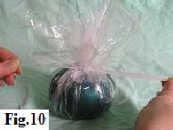 Tying off the cellophane with white curling ribbon