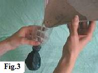 Begin filling the balloon with sand