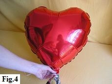 Inflating mylar balloon heart with helium. Inflating mylar balloon heart with helium.