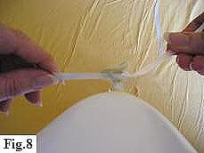 Attaching ribbon to latex balloon.