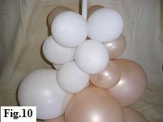 Bottom part of a peach and white balloon tower.