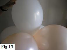 11 inch latex balloon at the top of a spiral balloon column.