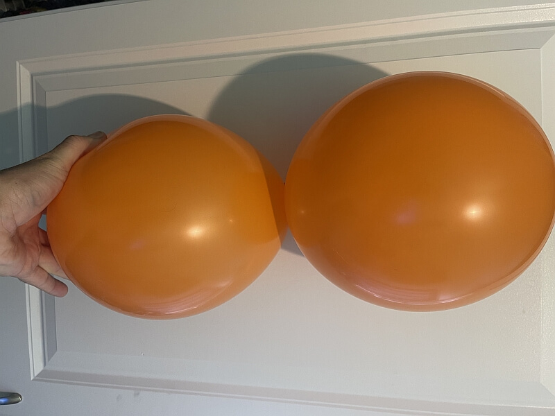 Two balloons tied together into a duplet.