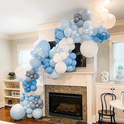 Organic balloon garland decorating a fireplace that's not in use (Image found at Walmart.com)