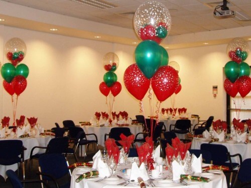Helium filled Christmas wedding balloon centerpieces in traditional red and green colors.