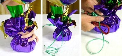 DIY balloon weights made with a sand filled bag wrapped in purple, green and gold foil paper.