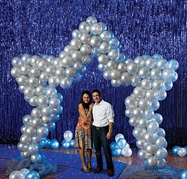 Star shaped balloon arch with a couple standing beneath