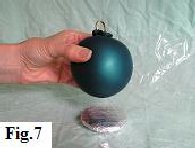Putting the sand filled balloon onto a small cake board