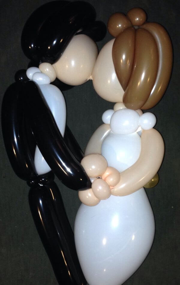 Kissing bride and groom balloon sculptures